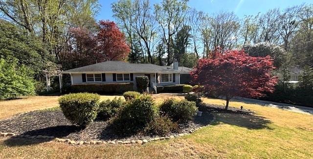 4519 Sims Ct, Tucker, GA 30084 - ranch-style house featuring a front yard and a chimney