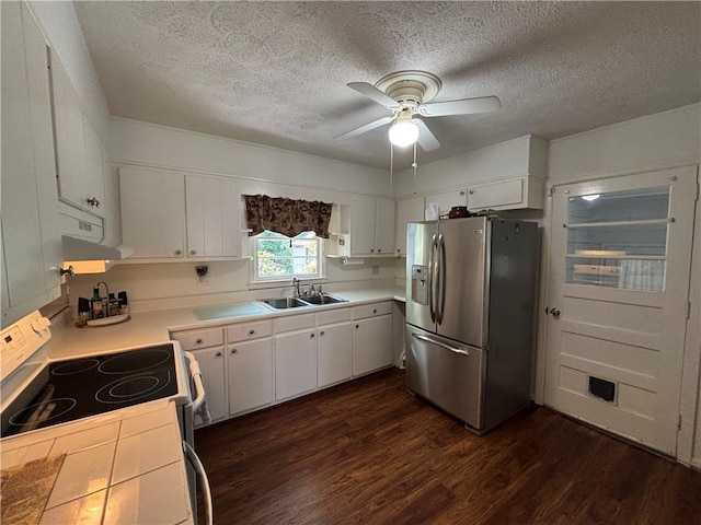 4519 Sims Ct, Tucker, GA 30084 - kitchen featuring white electric range oven, stainless steel fridge, a sink, dark wood finished floors, and range hood