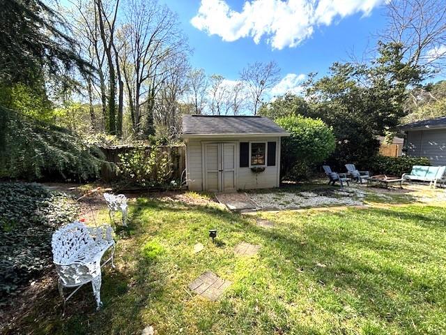 4519 Sims Ct, Tucker, GA 30084 - view of outdoor structure featuring fence, an outdoor structure, and a fire pit