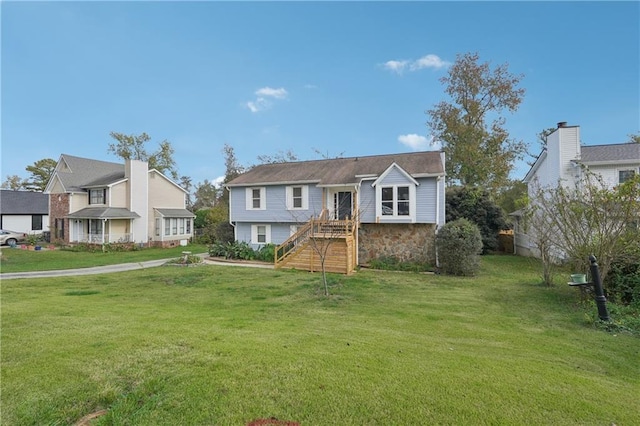 view of front of property featuring a front lawn and stone siding
