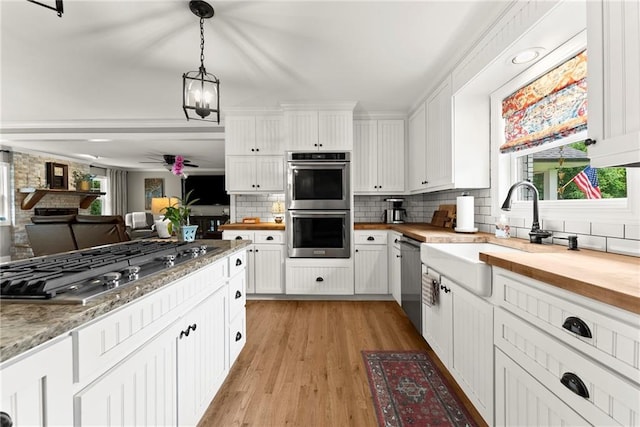 322 Windy Ridge Dr, Demorest, GA 30535 - kitchen featuring appliances with stainless steel finishes, butcher block counters, plenty of natural light, and white cabinets