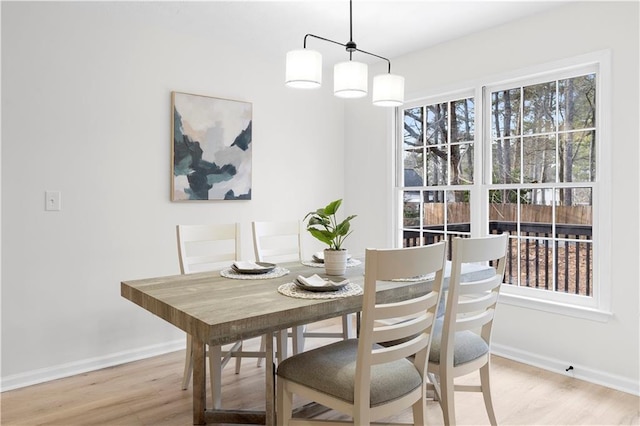 dining space with light hardwood / wood-style floors