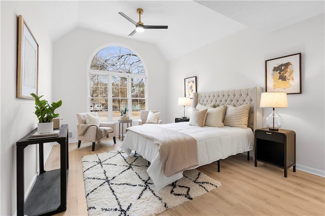 bedroom featuring ceiling fan, lofted ceiling, and light wood-type flooring