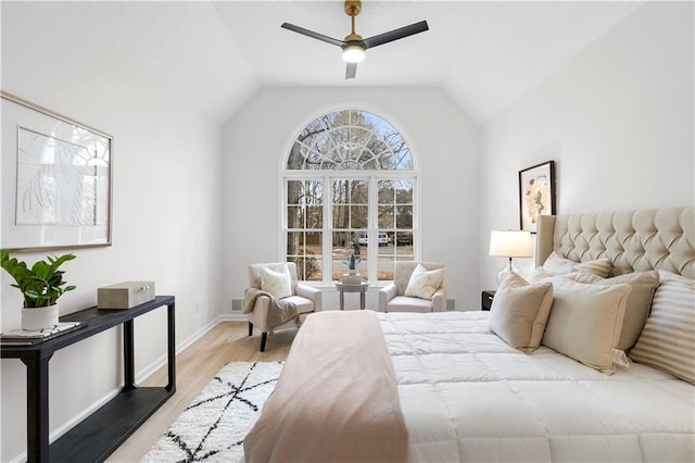 bedroom with ceiling fan, lofted ceiling, and light hardwood / wood-style flooring