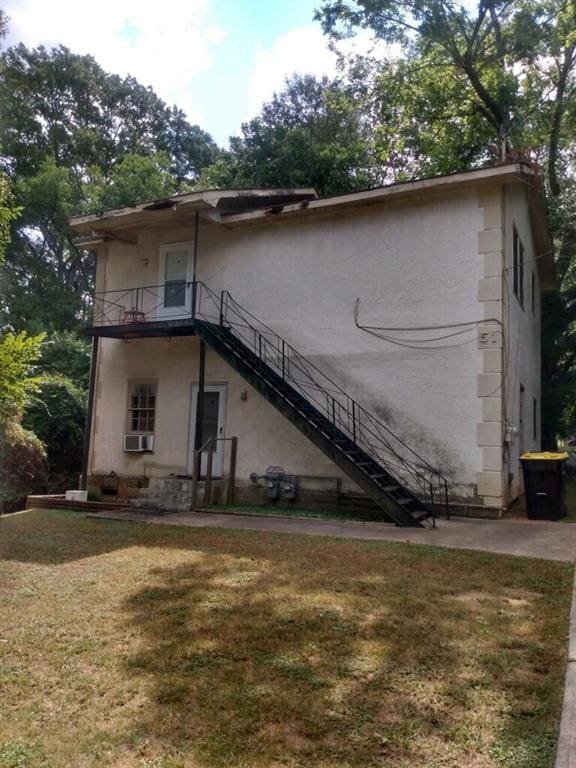 51 Mullis St, Fairburn, GA 30213 - back of house with stairs, a yard, stucco siding, and a balcony
