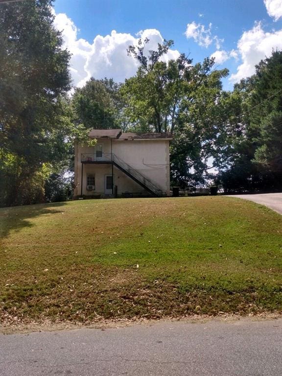 51 Mullis St, Fairburn, GA 30213 - view of property exterior featuring stucco siding and a lawn