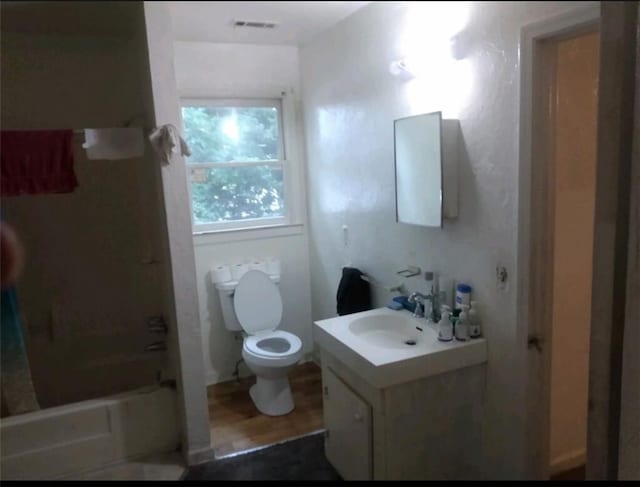51 Mullis St, Fairburn, GA 30213 - bathroom with vanity, toilet, shower / washtub combination, and wood finished floors