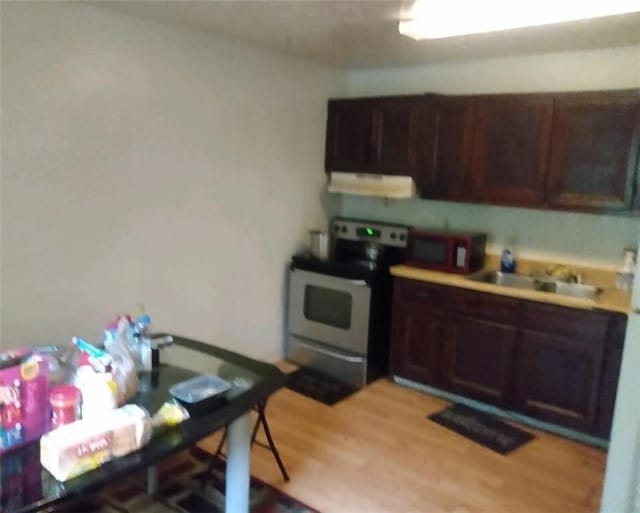 51 Mullis St, Fairburn, GA 30213 - kitchen with electric range, extractor fan, a sink, light wood-style floors, and dark brown cabinets