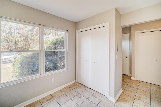 unfurnished bedroom with light tile patterned flooring