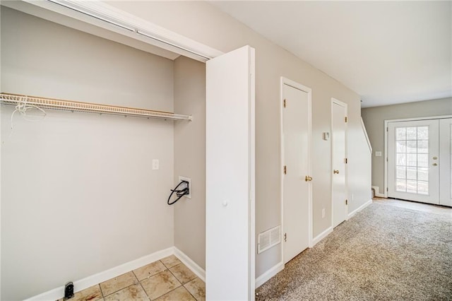 laundry room with light colored carpet