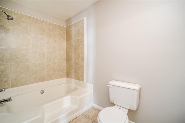 bathroom with tiled shower / bath combo, tile patterned floors, and toilet