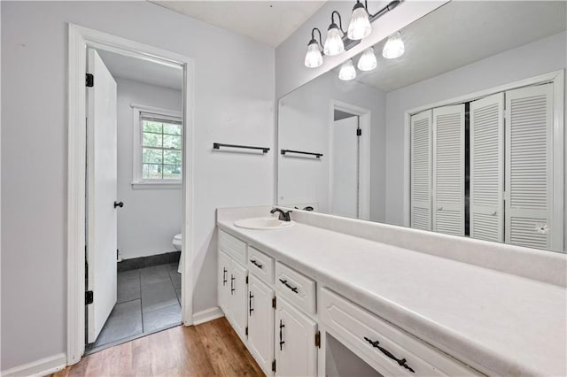 120 Lakeside Dr, Ellenwood, GA 30294 - bathroom with a closet, vanity, and wood finished floors