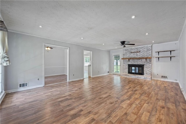 120 Lakeside Dr, Ellenwood, GA 30294 - unfurnished living room with ceiling fan, ornamental molding, a textured ceiling, wood finished floors, and recessed lighting