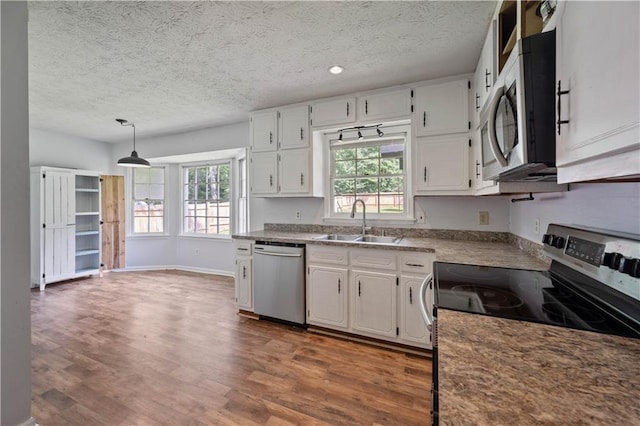 120 Lakeside Dr, Ellenwood, GA 30294 - kitchen featuring stainless steel appliances, a textured ceiling, dark wood-type flooring, and white cabinets
