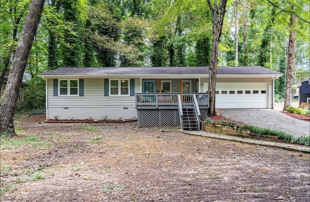 single story home featuring crawl space, covered porch, an attached garage, and asphalt driveway