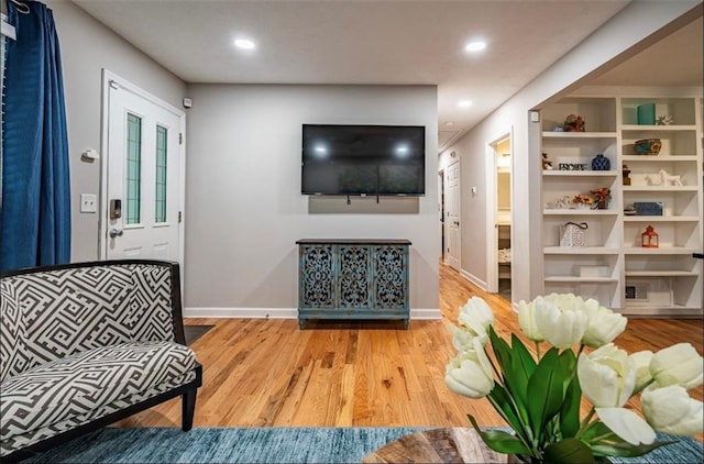 living area with wood finished floors, baseboards, and recessed lighting