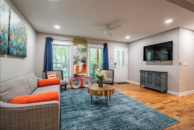 living area featuring wood finished floors, a ceiling fan, baseboards, and recessed lighting
