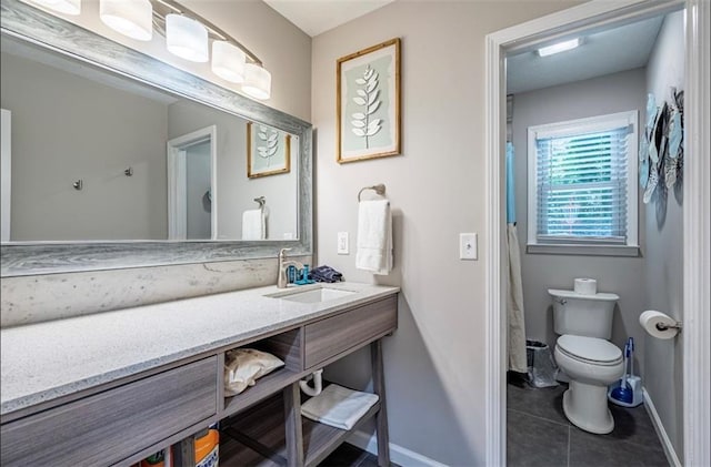 full bathroom with baseboards, toilet, vanity, and tile patterned floors