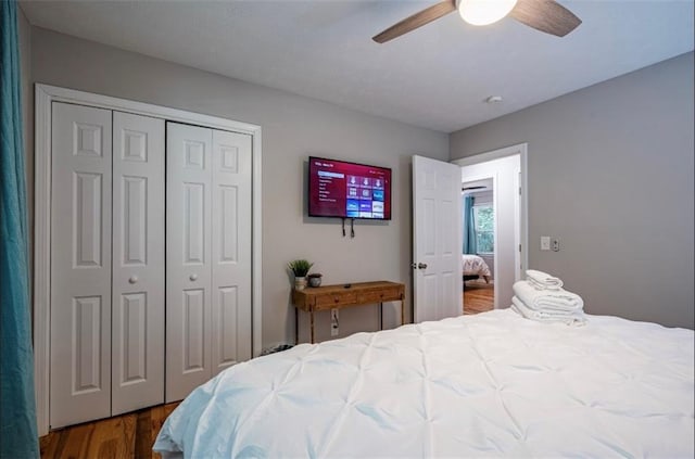 bedroom with a closet, wood finished floors, and ceiling fan
