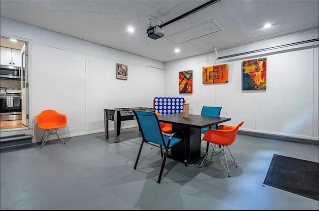 dining space with attic access, concrete flooring, recessed lighting, and baseboards