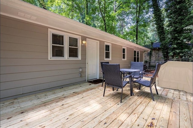 wooden deck featuring outdoor dining area