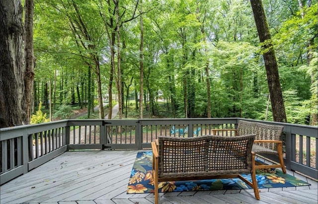 wooden terrace featuring a wooded view