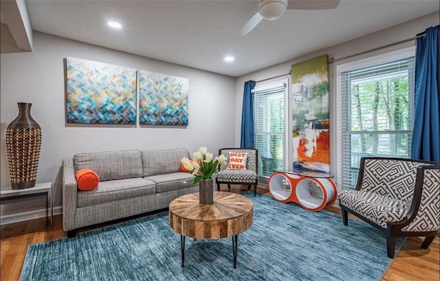 living area with wood finished floors, a ceiling fan, and recessed lighting