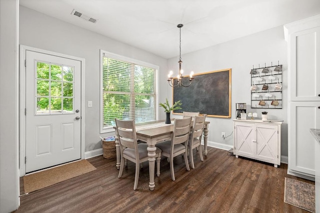 dining space featuring dark wood-style floors, baseboards, visible vents, and a notable chandelier