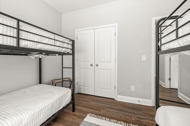 bedroom featuring a closet, baseboards, and wood finished floors