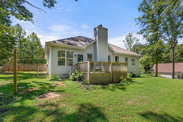 back of house featuring a yard, a chimney, crawl space, fence, and a deck