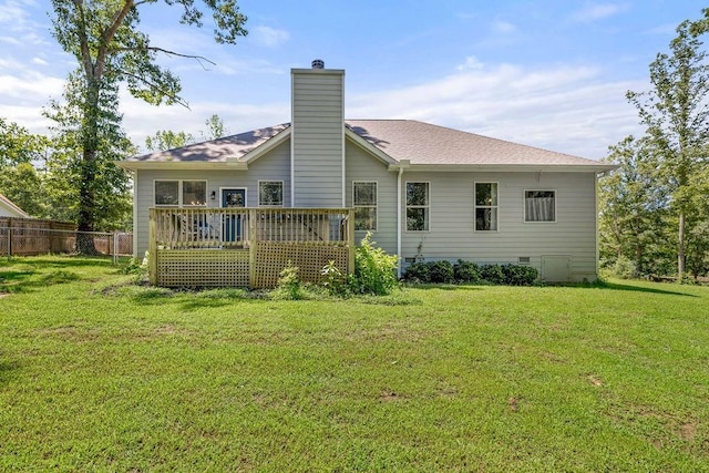 back of property with a yard, crawl space, a chimney, and fence