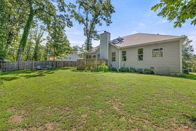 view of yard with a fenced backyard and a wooden deck