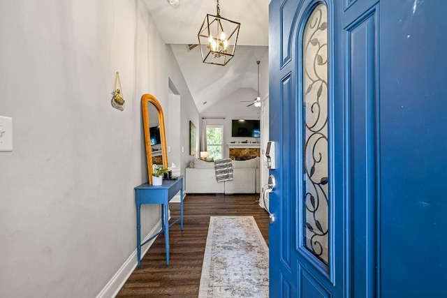 foyer with dark wood-style floors, baseboards, vaulted ceiling, and ceiling fan with notable chandelier