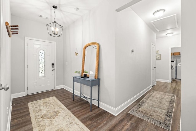 foyer entrance featuring baseboards, visible vents, dark wood finished floors, and washing machine and clothes dryer