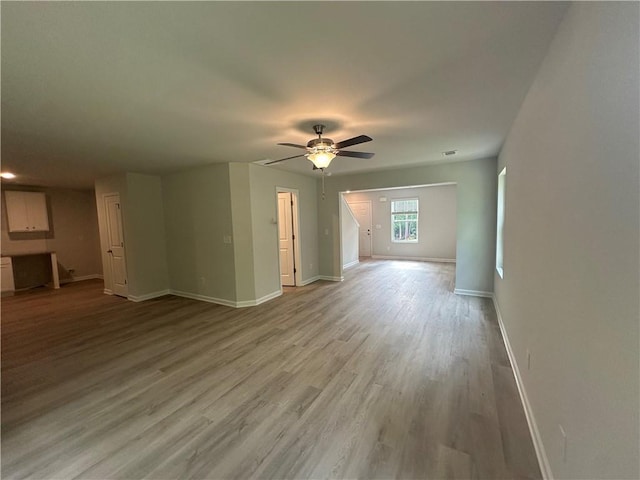 45 Emerald Ln, Covington, GA 30014 - unfurnished living room with baseboards, ceiling fan, and light wood finished floors