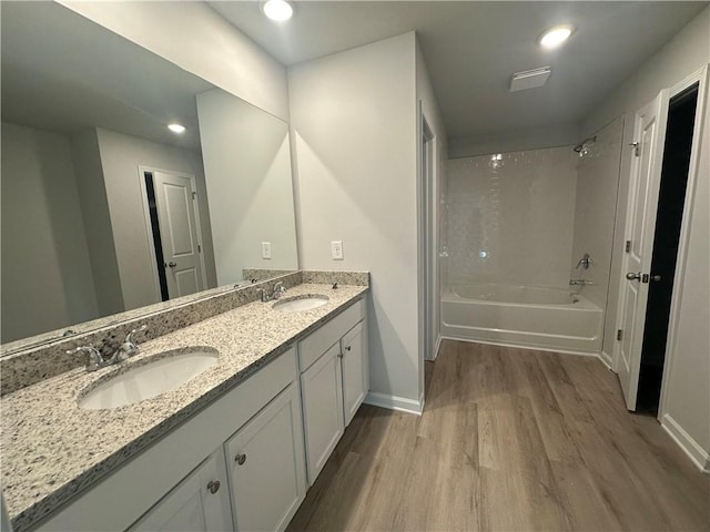 45 Emerald Ln, Covington, GA 30014 - full bath with wood finished floors, baseboards, double vanity, bathing tub / shower combination, and recessed lighting