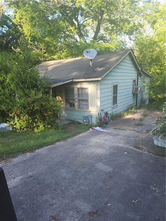 view of home's exterior with a shingled roof