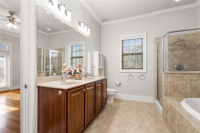 full bathroom with independent shower and bath, ornamental molding, vanity, ceiling fan, and toilet