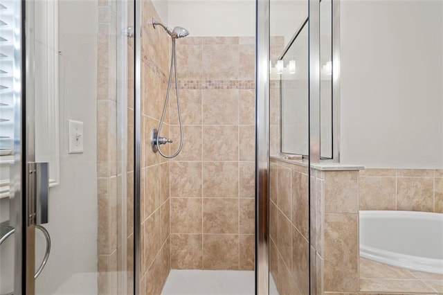 bathroom featuring shower with separate bathtub