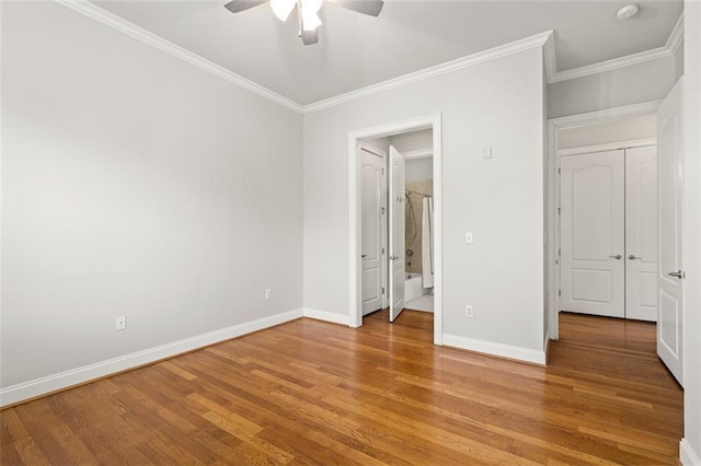 unfurnished bedroom with crown molding, ceiling fan, and hardwood / wood-style floors