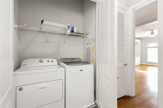 laundry area with hardwood / wood-style flooring, washing machine and clothes dryer, and ceiling fan