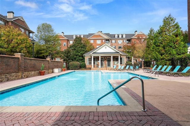 view of pool with an outbuilding and a patio area