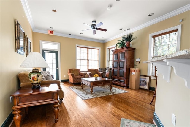 living room with ceiling fan, ornamental molding, and light wood-type flooring