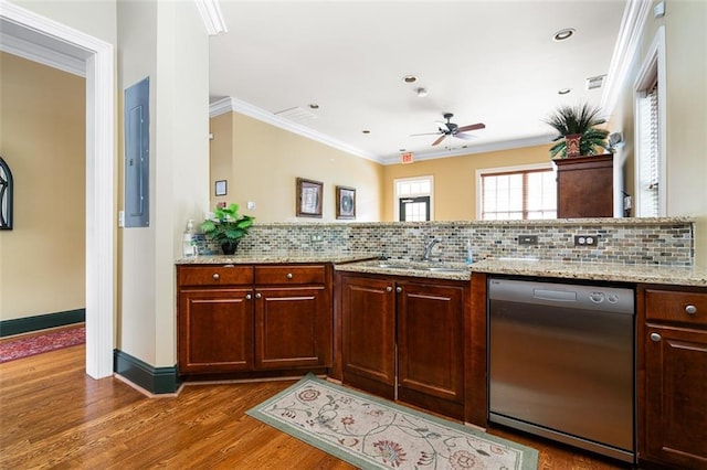 kitchen featuring sink, crown molding, backsplash, electric panel, and stainless steel dishwasher