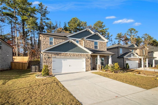 view of front of home with a front yard, a garage, and central AC unit