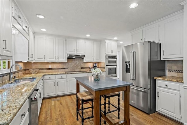4792 Fairville Ct, Marietta, GA 30062 - kitchen with appliances with stainless steel finishes, a sink, light wood-style flooring, white cabinets, and recessed lighting