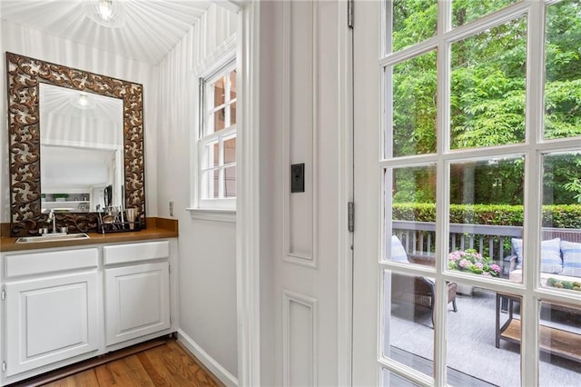 4792 Fairville Ct, Marietta, GA 30062 - doorway to outside with dark wood-style flooring, wet bar, and baseboards