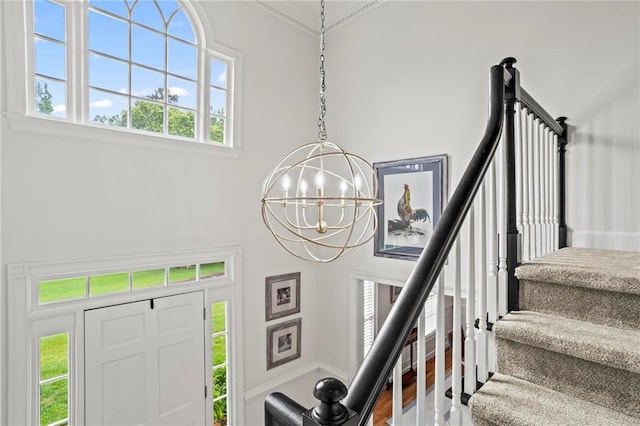 4792 Fairville Ct, Marietta, GA 30062 - staircase featuring a chandelier, ornamental molding, wood finished floors, and a high ceiling