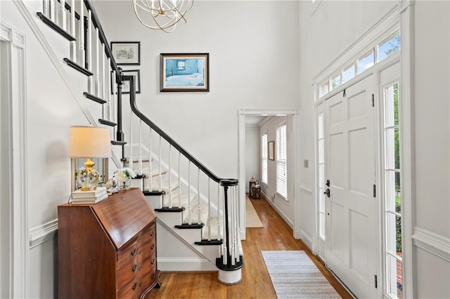 4792 Fairville Ct, Marietta, GA 30062 - foyer featuring stairway, wood finished floors, a chandelier, a high ceiling, and baseboards