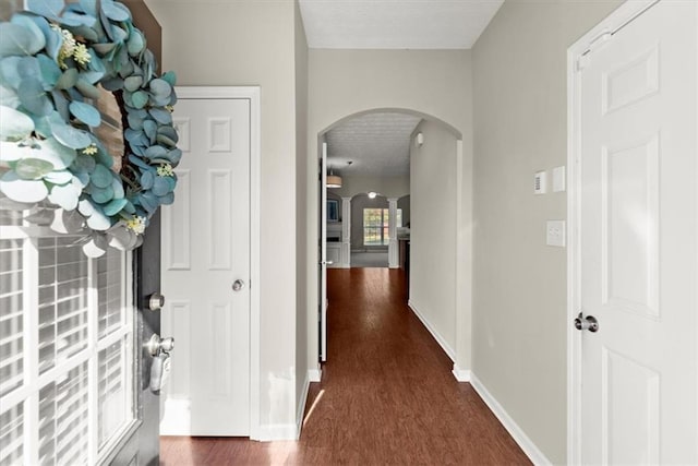 hall with dark hardwood / wood-style floors